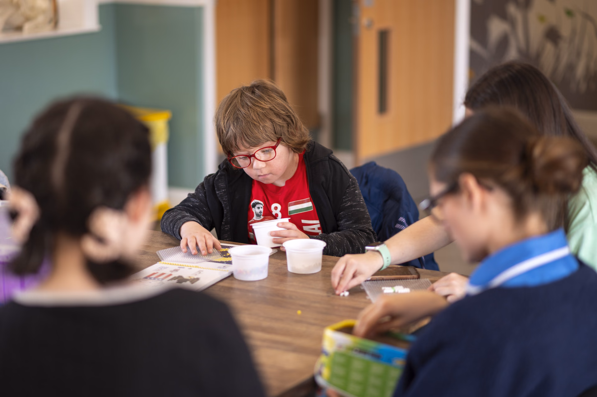 Children doing crafts with carers at Rebecca House