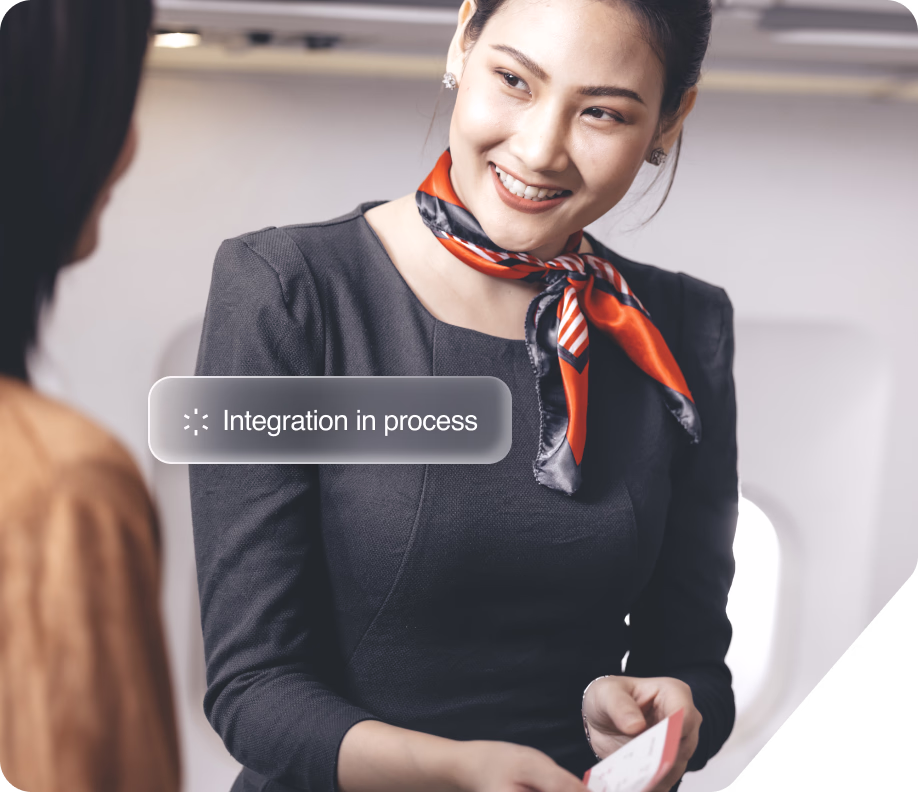 Flight attendant in uniform smiling at a passenger