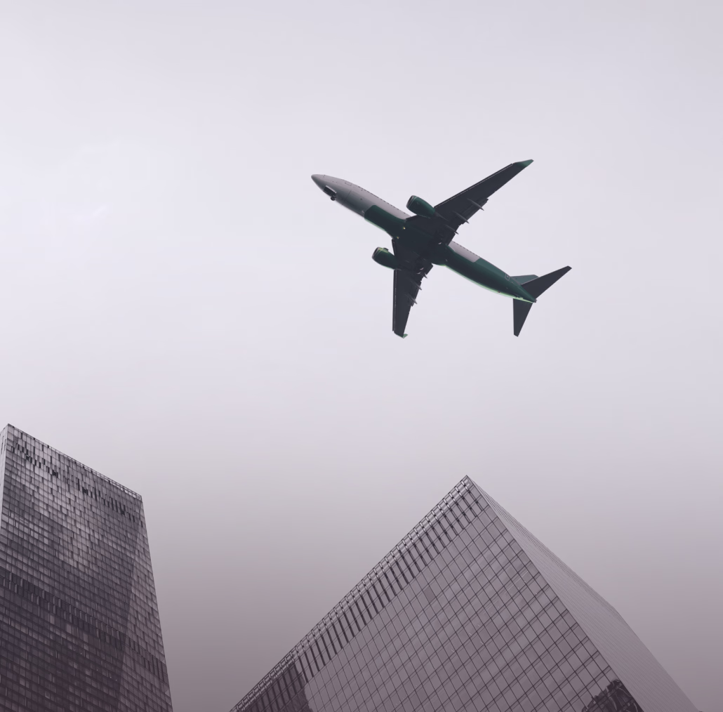 Aircraft flying over city buildings