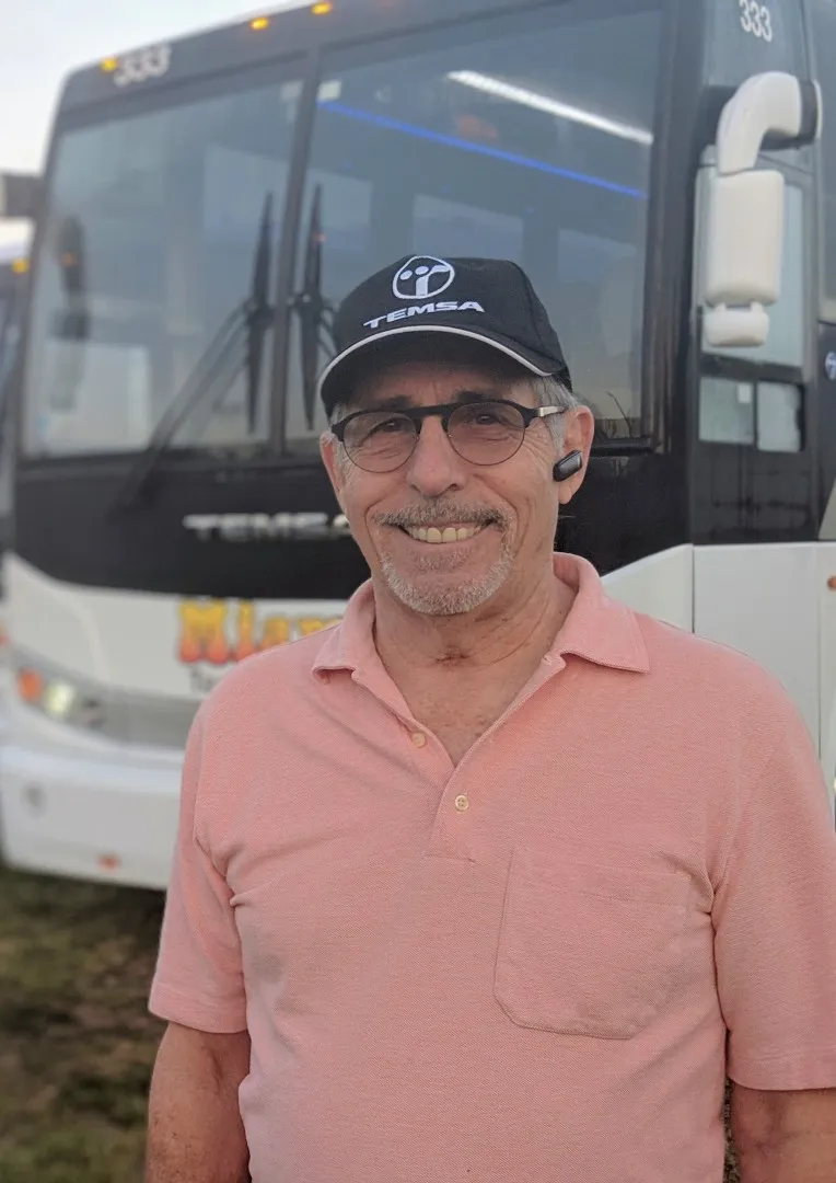 Friendly bus driver greeting passengers