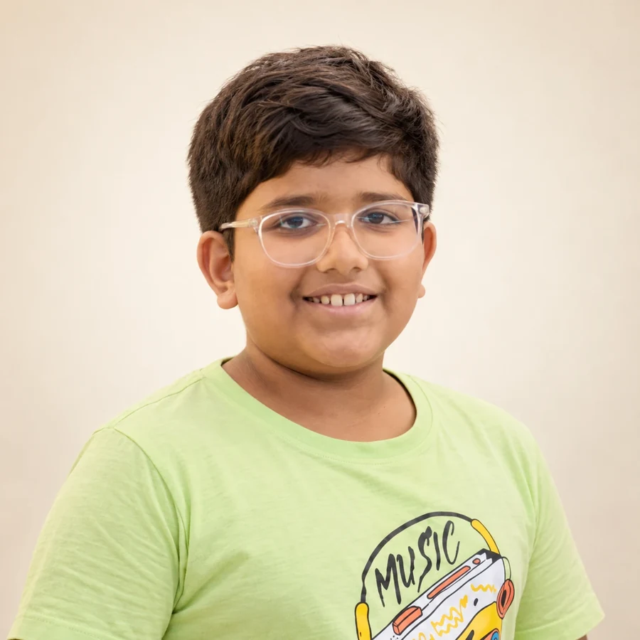 The youngest member of the VinayakM team, a smiling boy in a green t-shirt