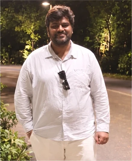 Before: the VinayakM member at 115 kg, standing on a garden path at night.