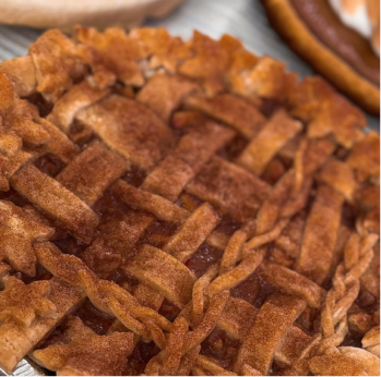 Close-up of a lattice-topped apple pie with a braided crust.