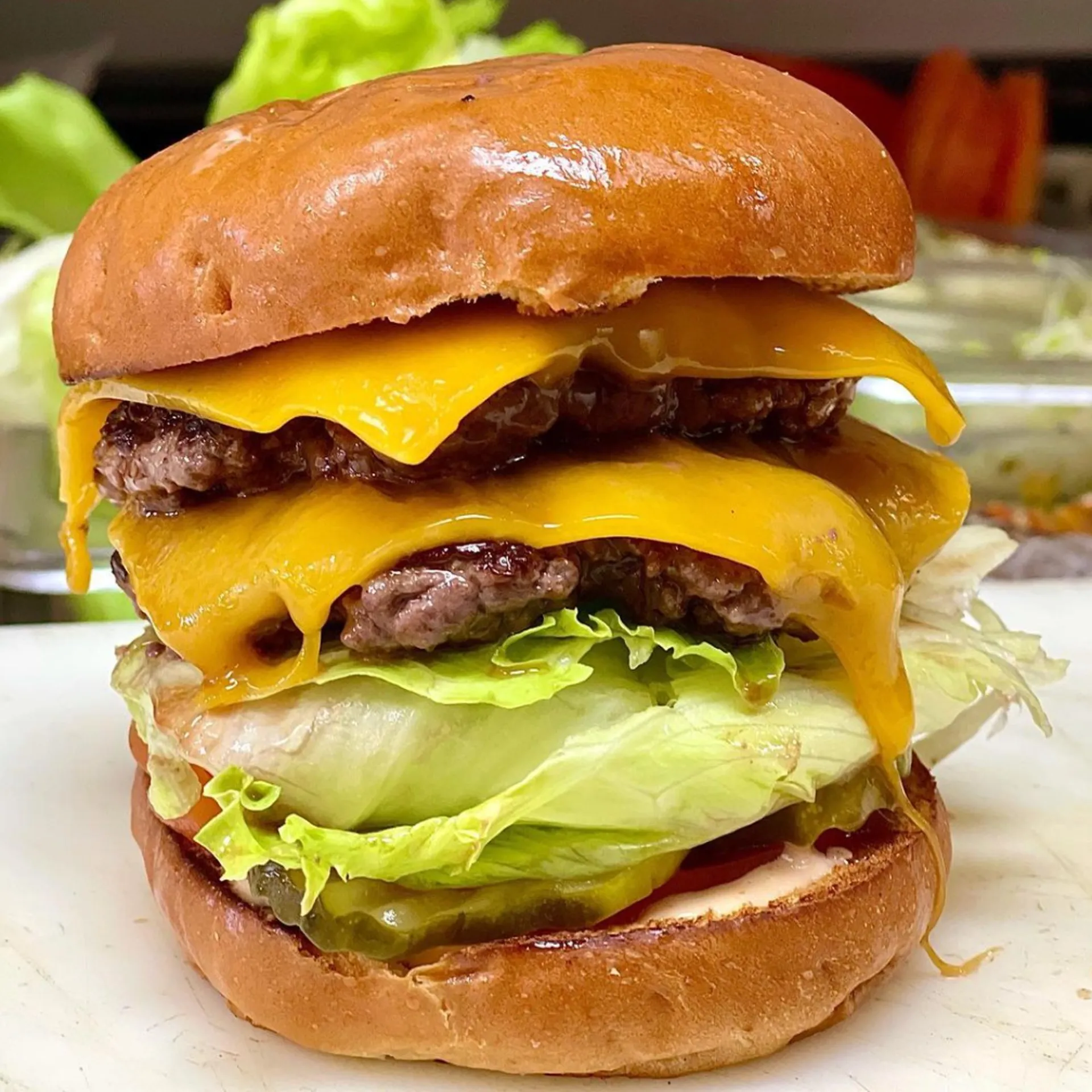 A juicy double cheeseburger with two beef patties, melted cheddar, fresh lettuce, and a golden bun.