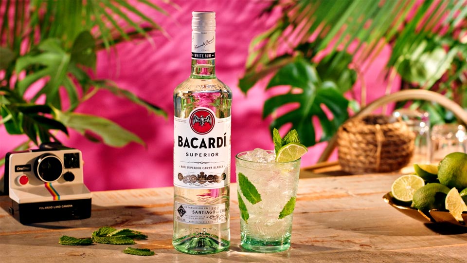 Luxury drink styling scene featuring a Bacardi Superior White Rum bottle and mojito cocktail on a custom tabletop, captured in Philadelphia by Big River Film Co. with vibrant tropical lighting and premium food and beverage cinematography.