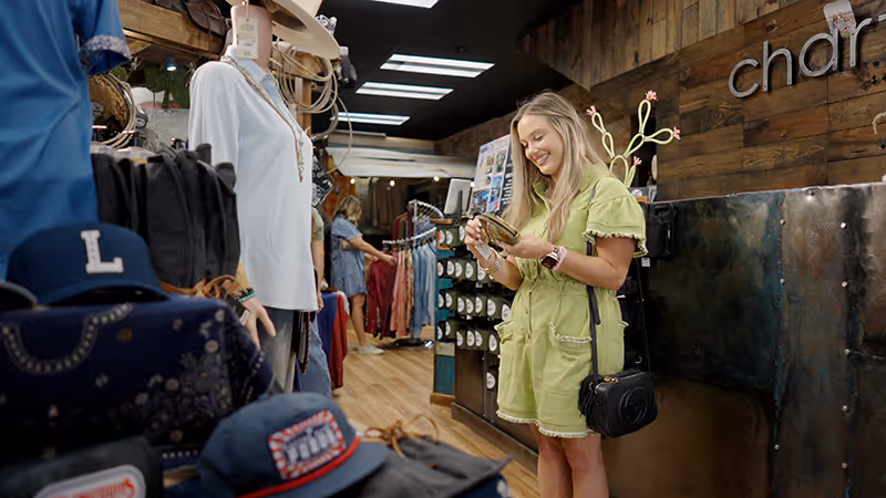 Young woman in yellow outfit shopping in a western store, downtown Kaufman, TX