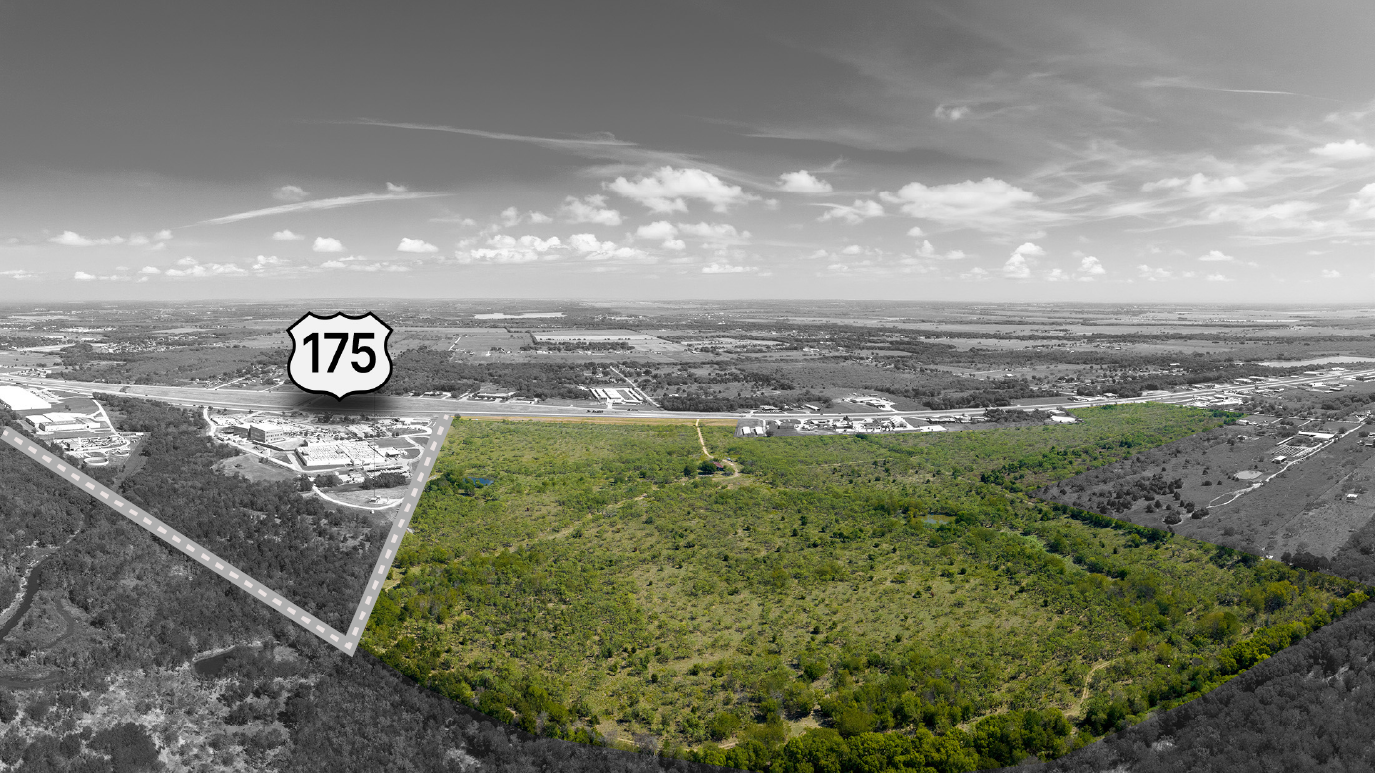 Aerial view of green forested land highlighted near US highway 175 with surrounding areas in grayscale.