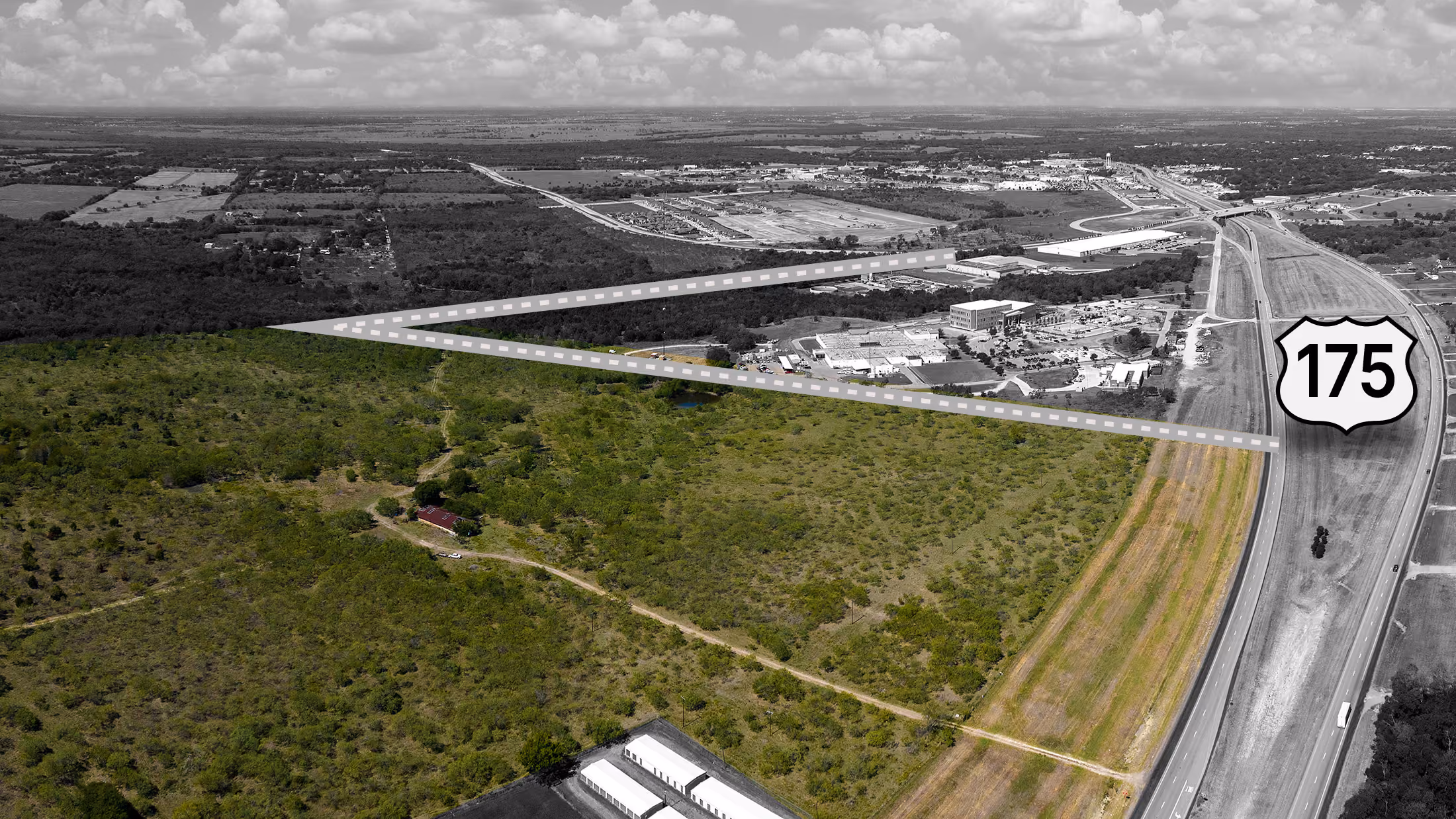 Aerial view of highway 175 with a marked triangular land area showing a mix of forest and industrial buildings.