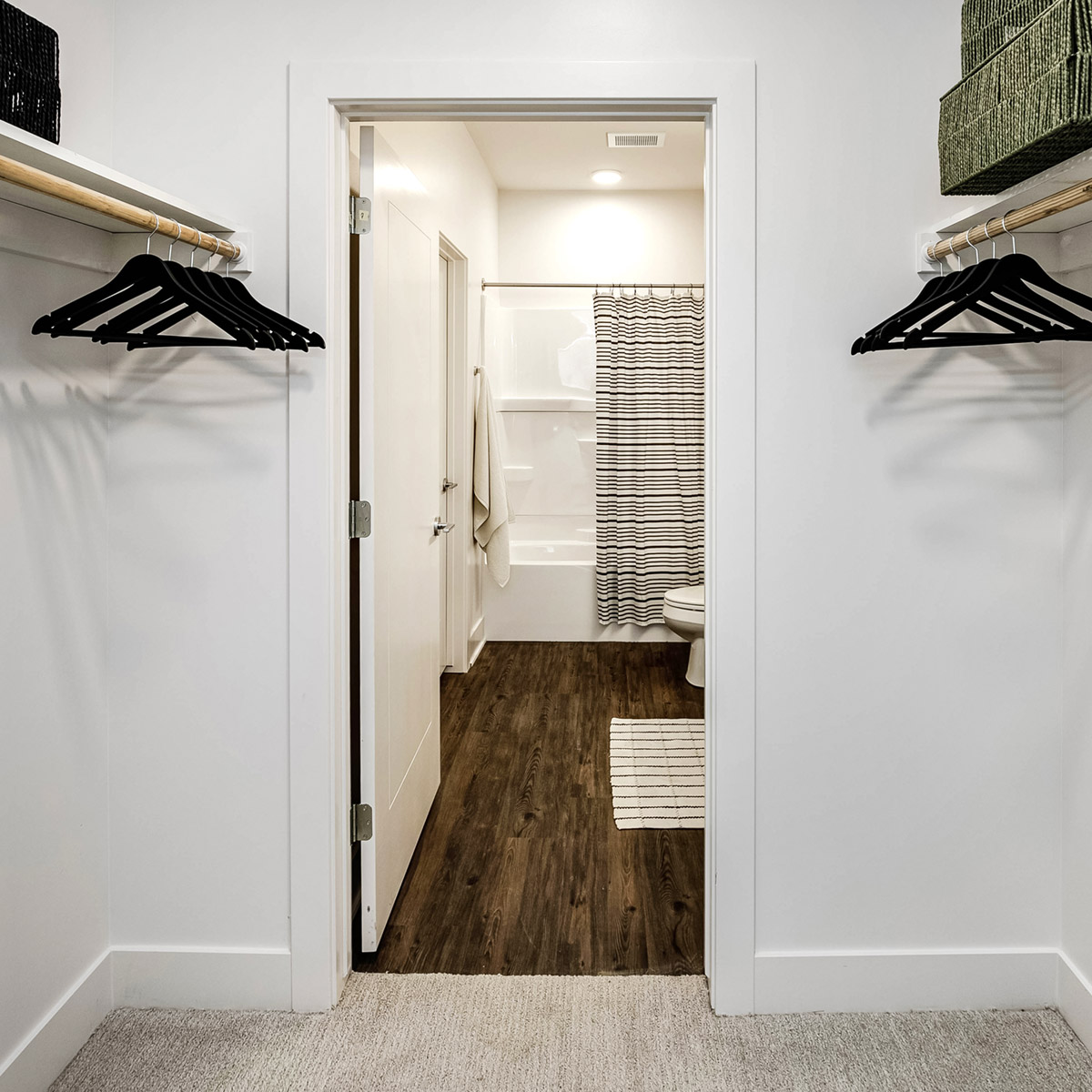 Walk in closet with entrance to the bathroom 