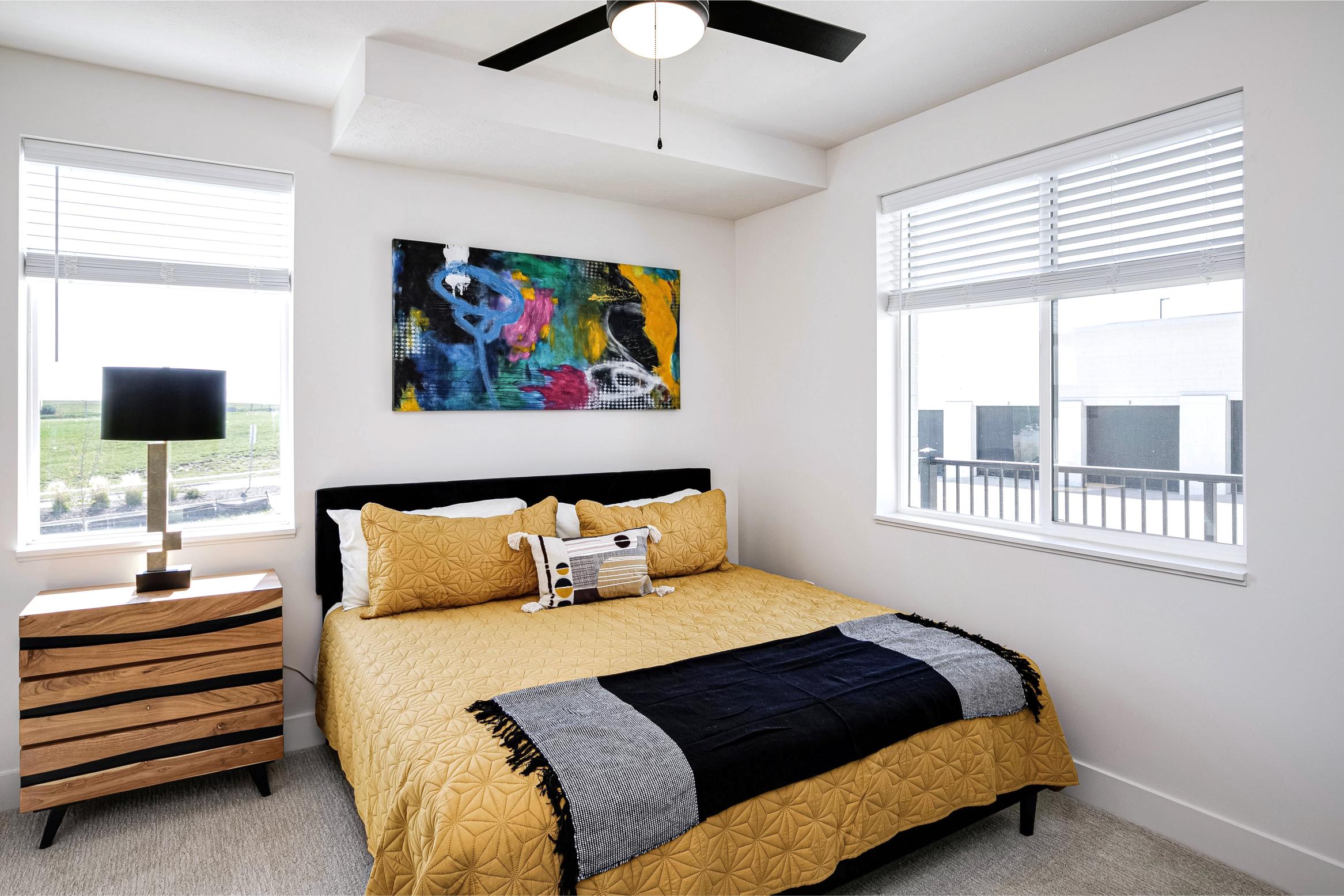 model bedroom view with yellow comforter