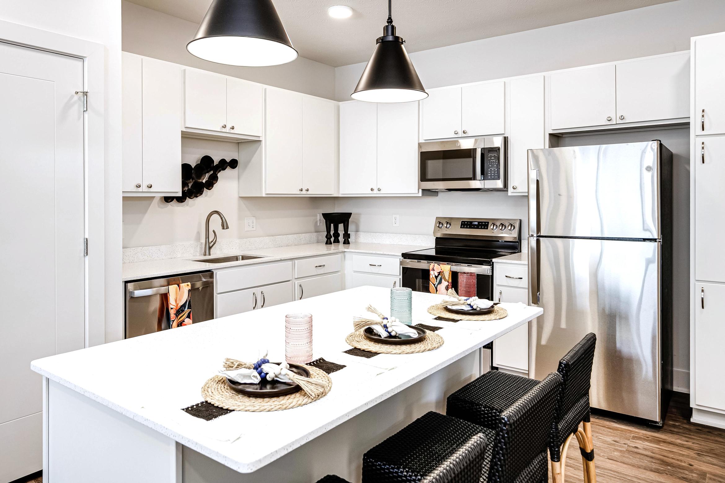 kitchen view showing the island with white cabinets and countertops