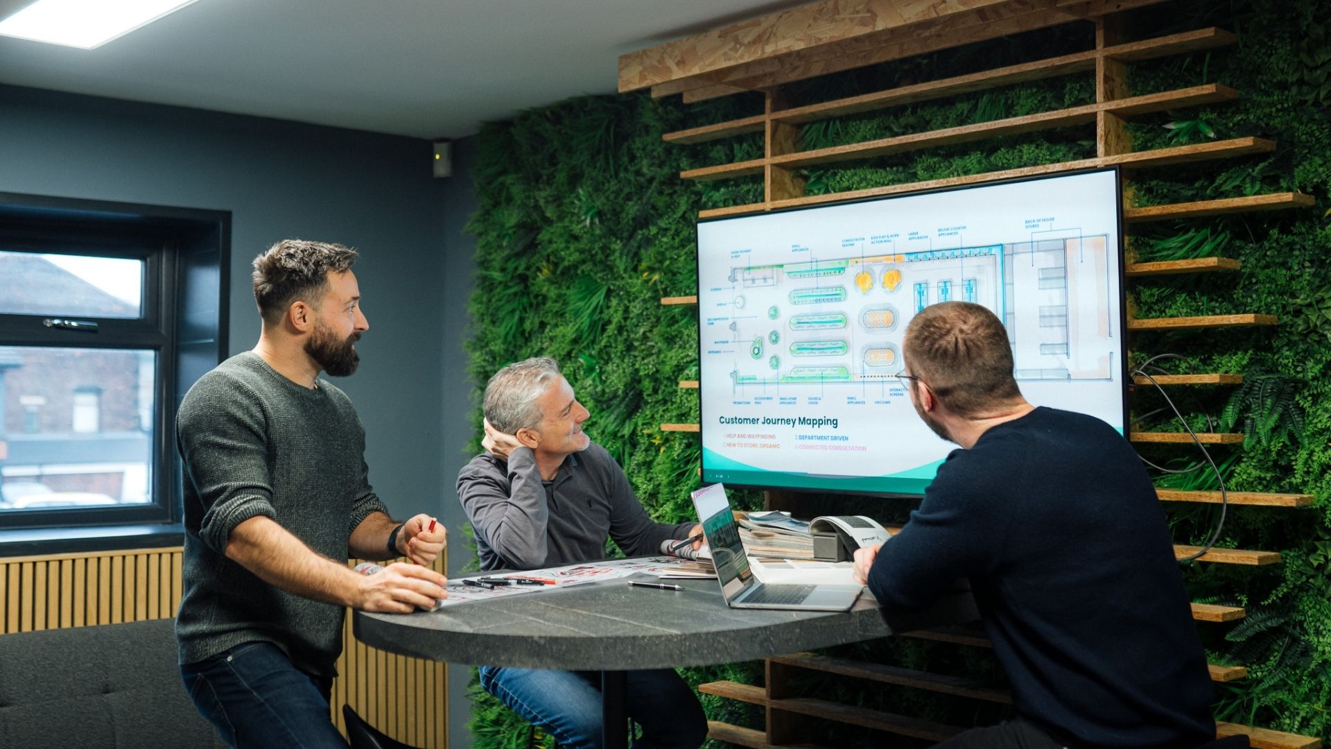 Team reviews customer journey map on screen