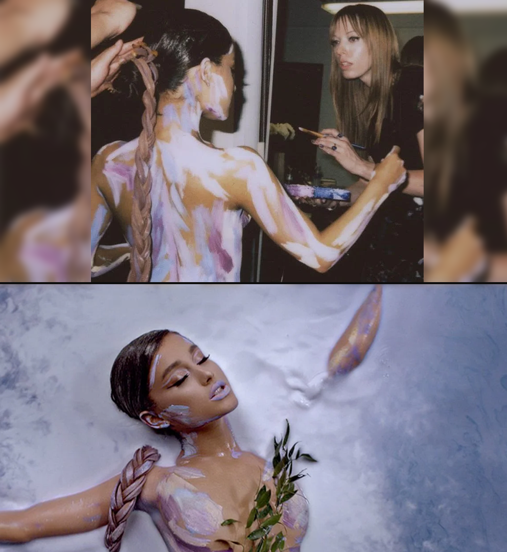 Two images of a woman with painted body and long braided hair; top image shows a makeup artist applying body paint, bottom image shows the woman lying in a milky liquid with leaves on her chest.