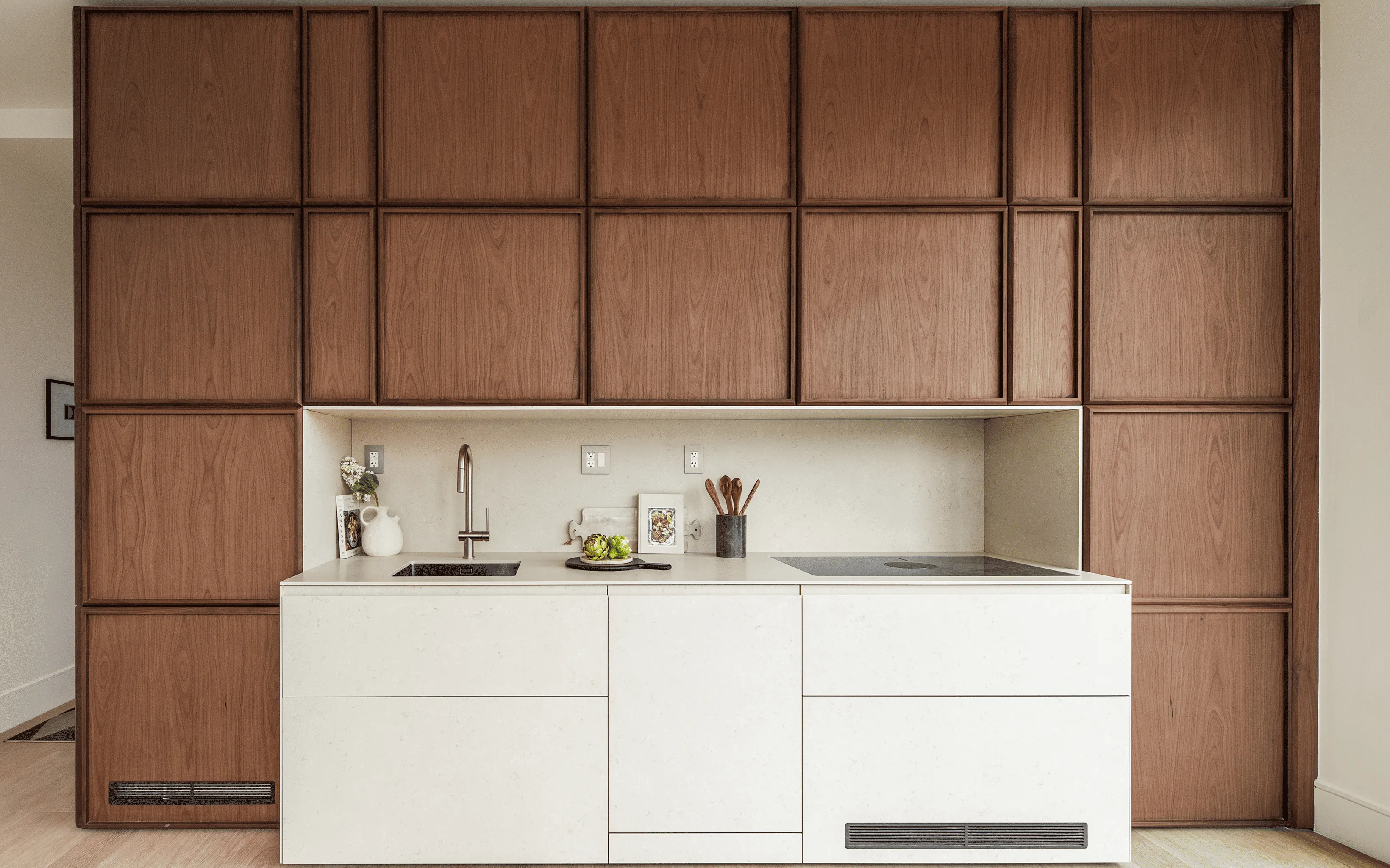 Curved white concrete architecture against a clear blue sky, showcasing smooth lines and modern design elements.