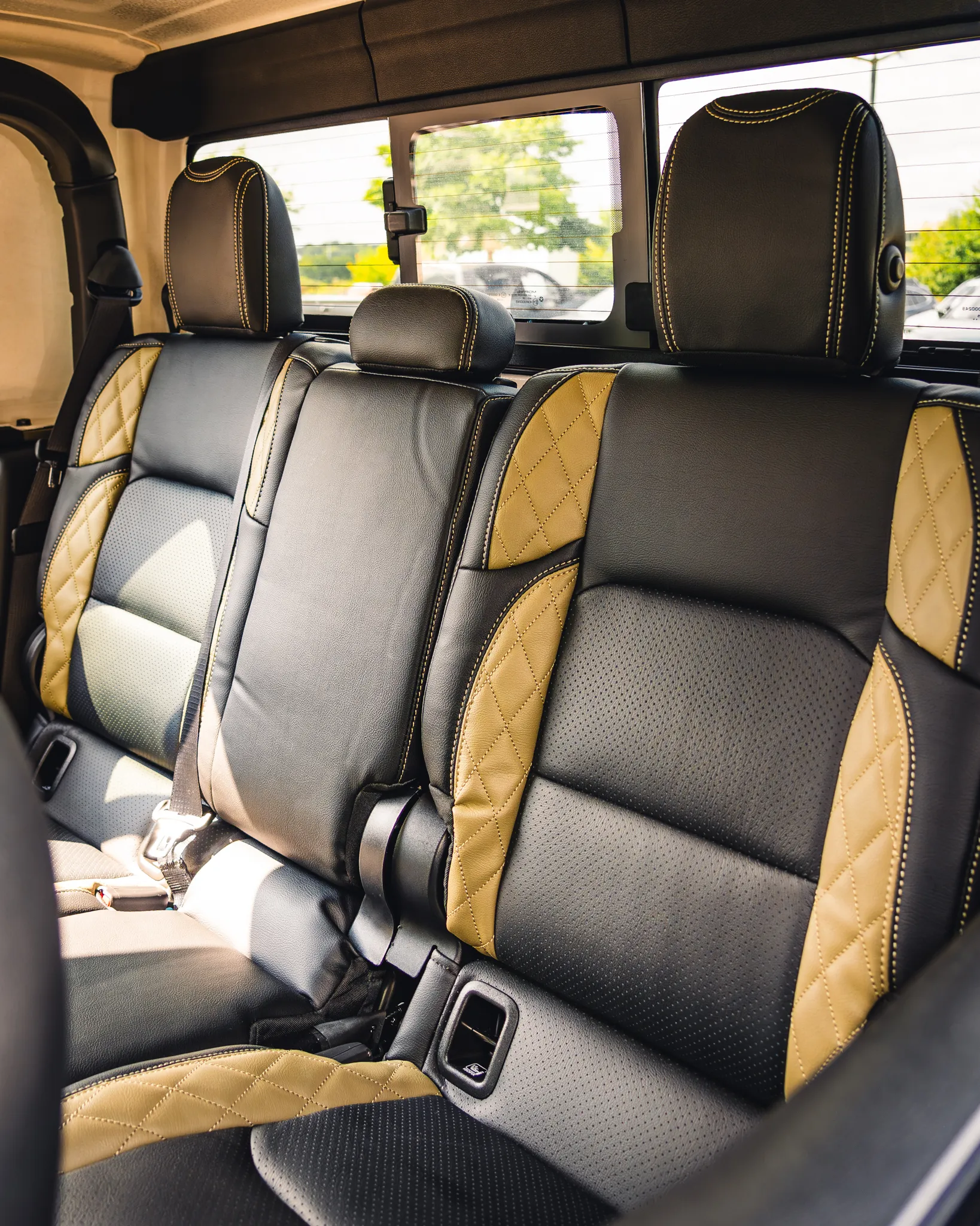 A row of customized black and yellow Katzkin leather seats professionally installed by Madison Auto Trim, LLC.