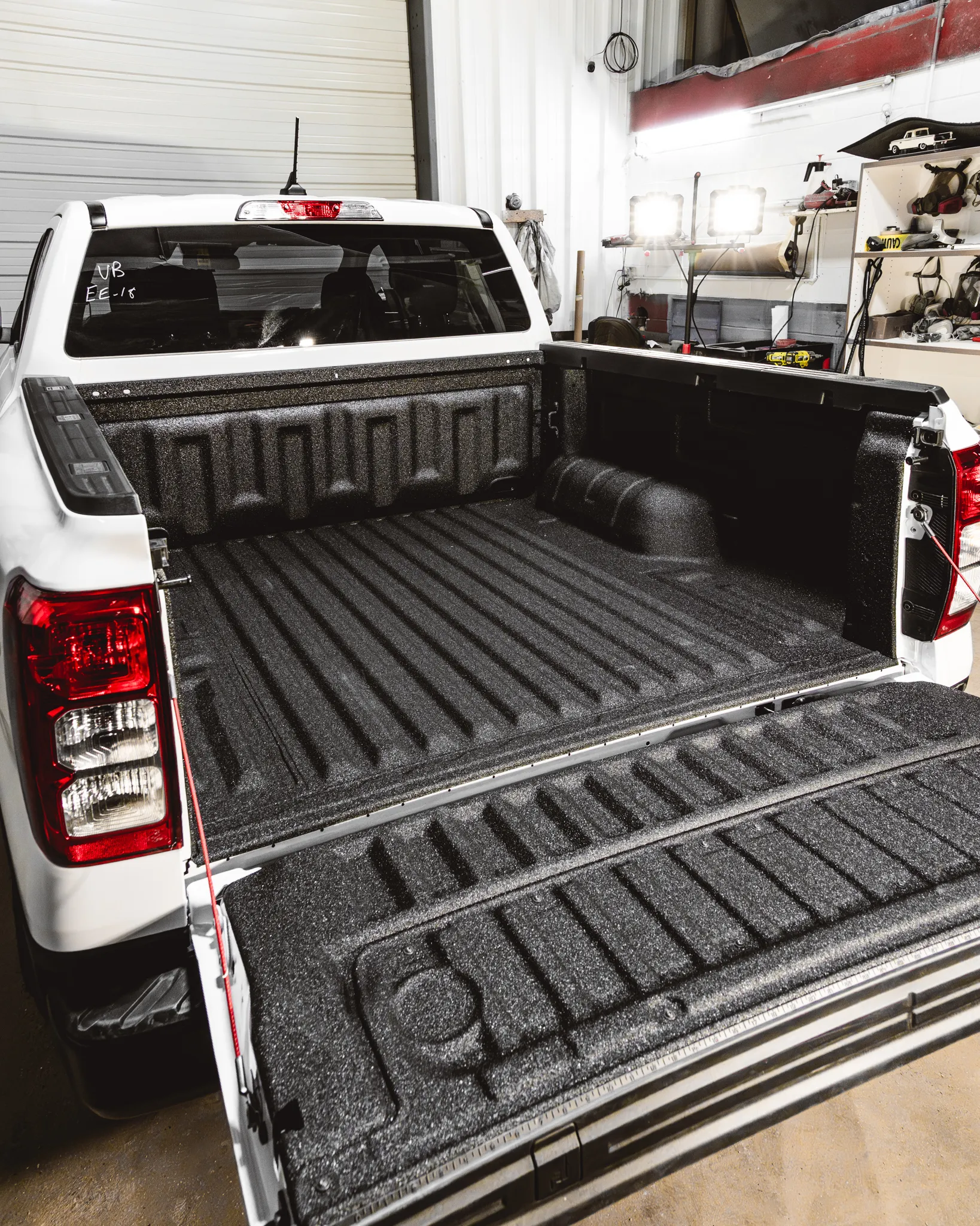 A white pickup truck just moments after a fresh, professional spray-in bedliner installation at Madison Auto Trim, Wisconsin.