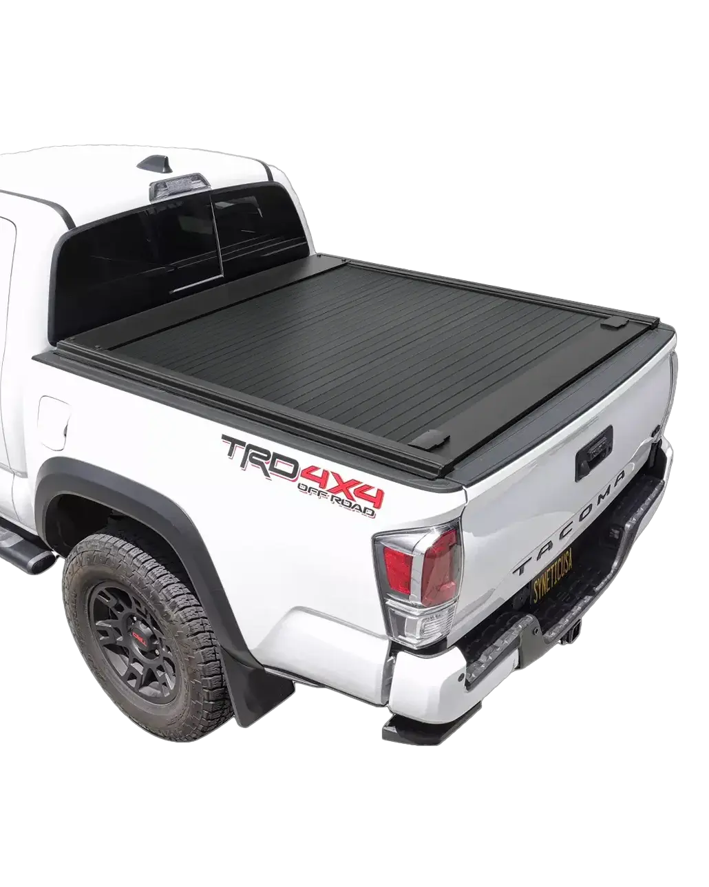 A white Toyota Tacoma with an electric hard tonneau cover installed