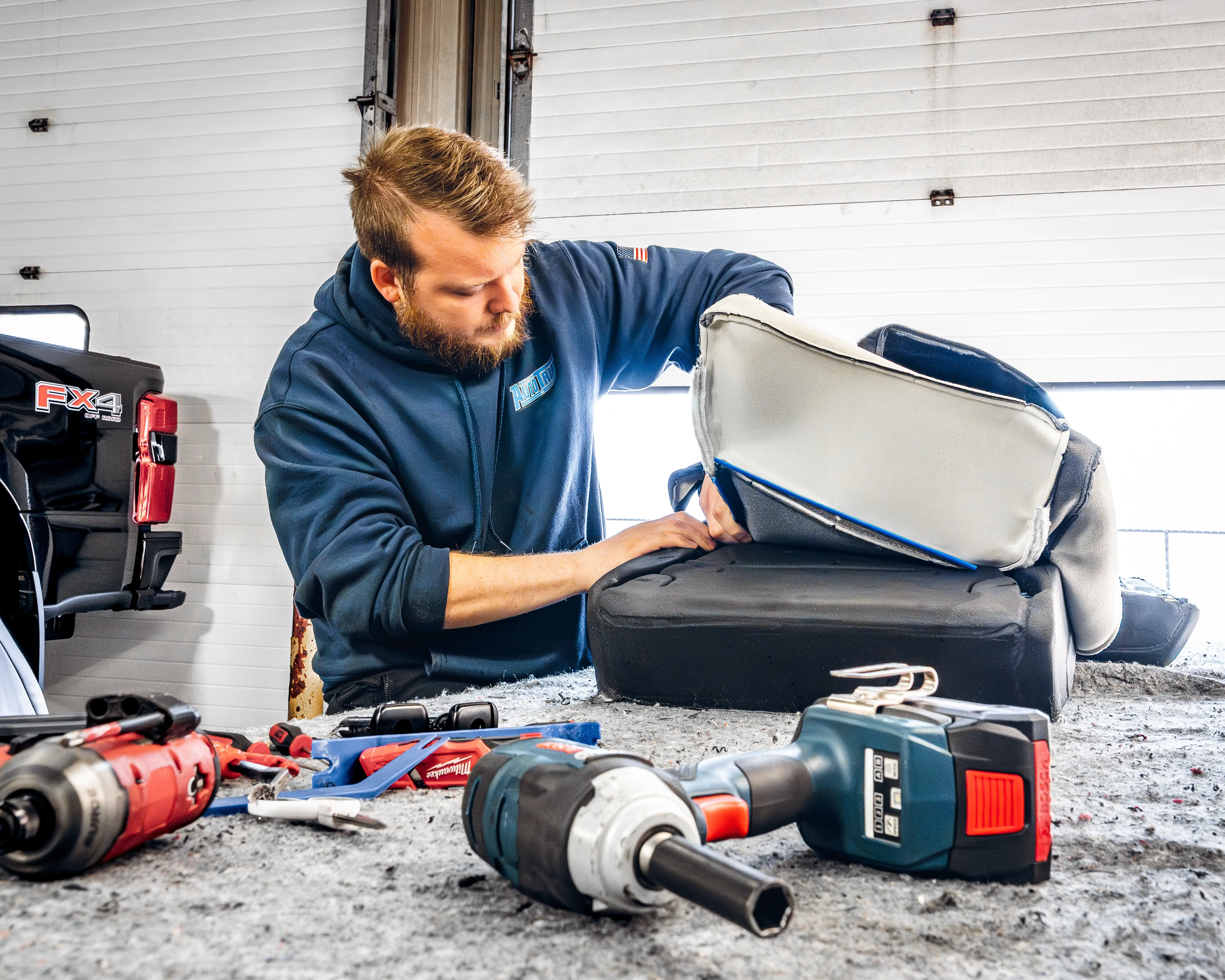 Three seats in a single row of grey and white custom Katzkin leather rear seats professionally installed by Madison Auto Trim, Wisconsin.