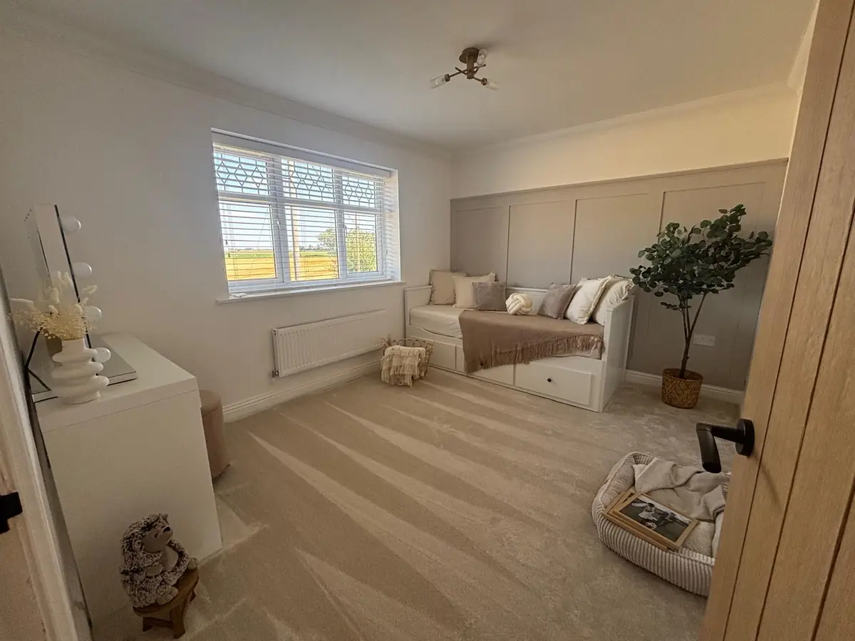 The same Hampton bedroom after: soft beige carpet fitted wall to wall