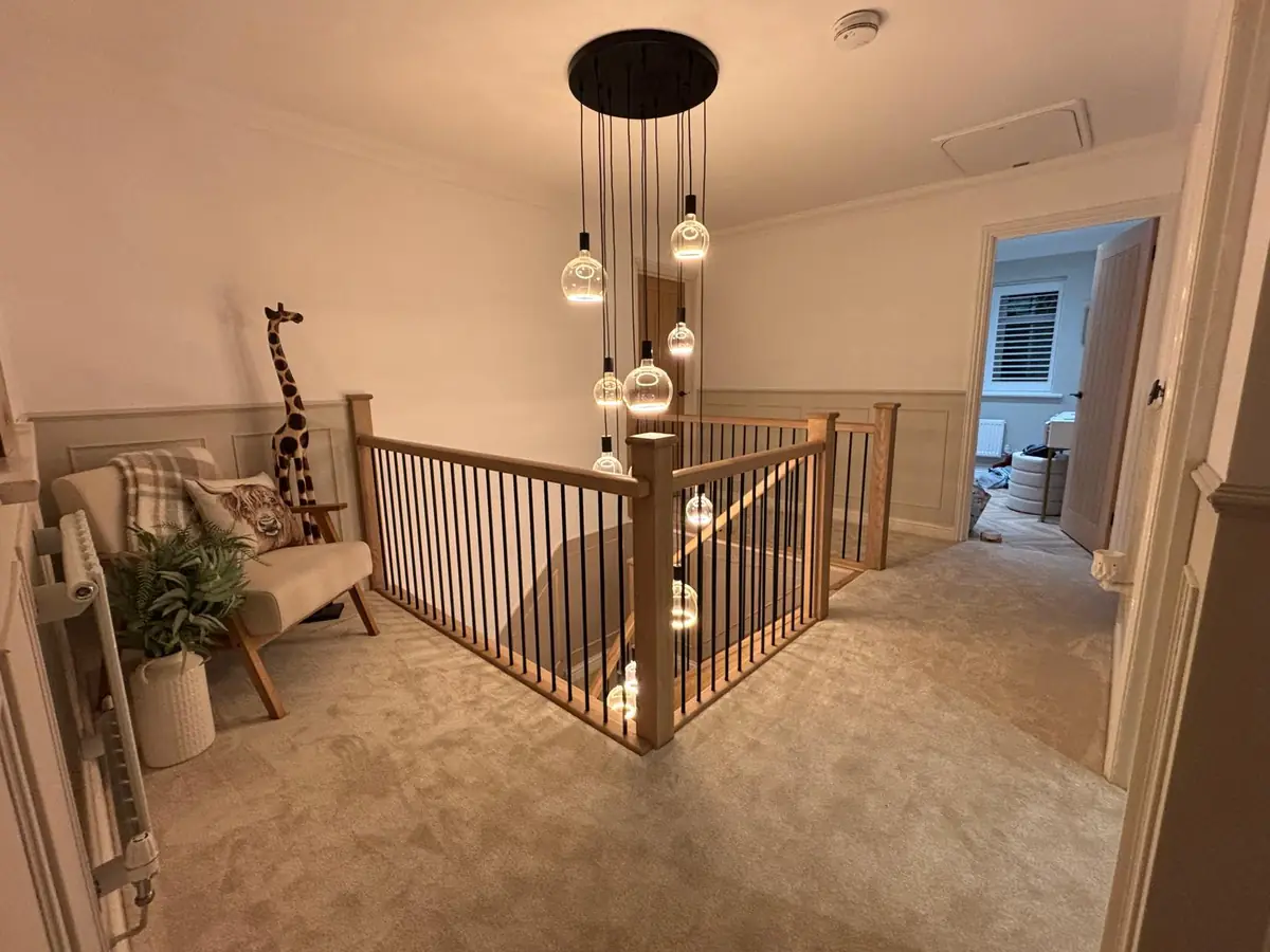 The same landing after: neutral carpet fitted around the balustrade and down the stairs