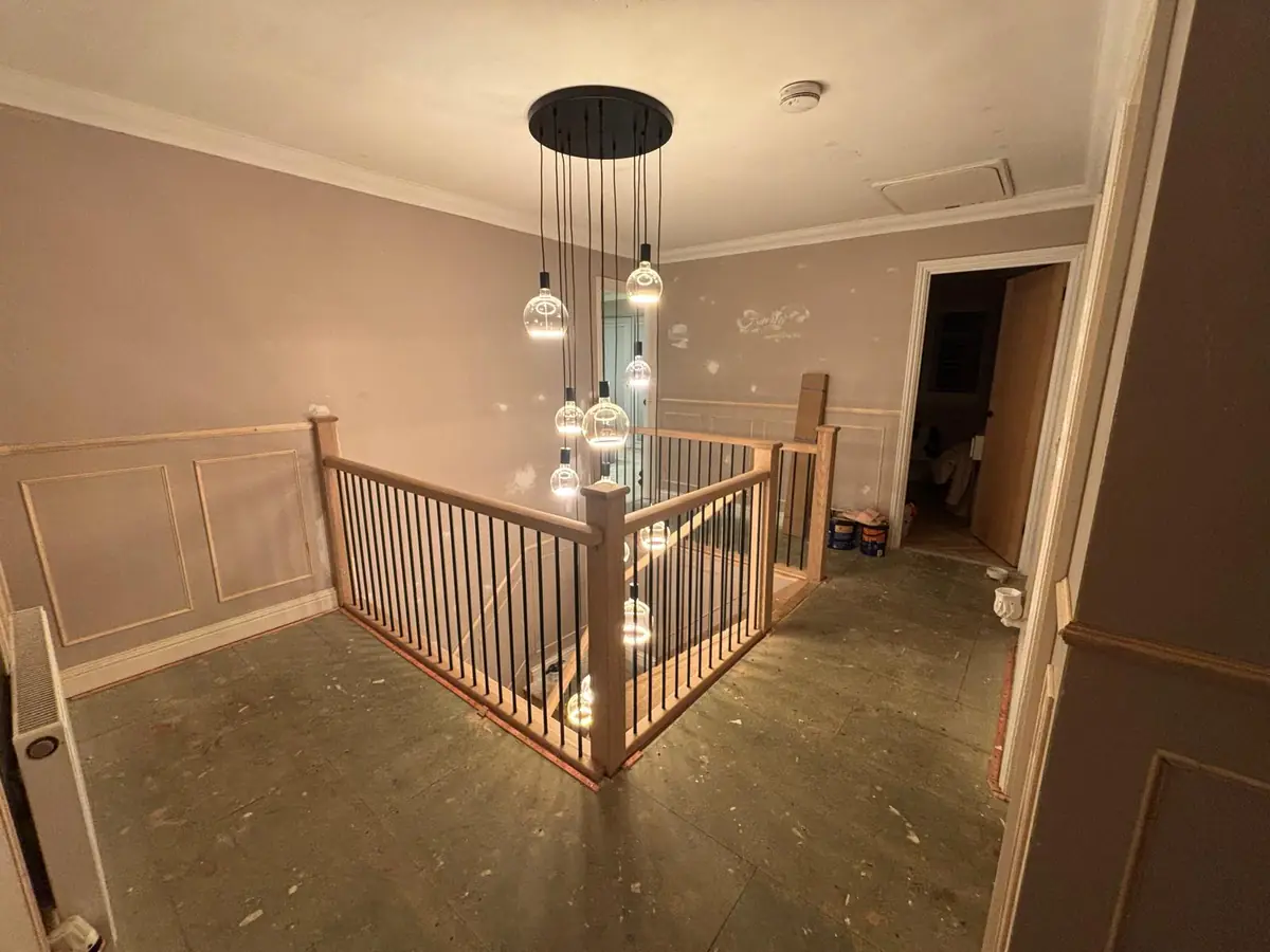 Landing in Hampton before: bare boards around a new oak balustrade