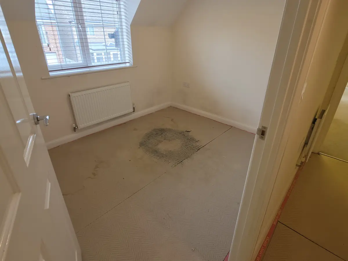 Loft bedroom in Stanground before: old underlay and gripper exposed