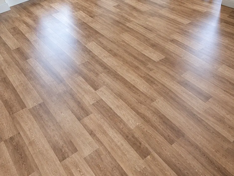 The same kitchen-diner after: wood-effect flooring fitted wall to wall