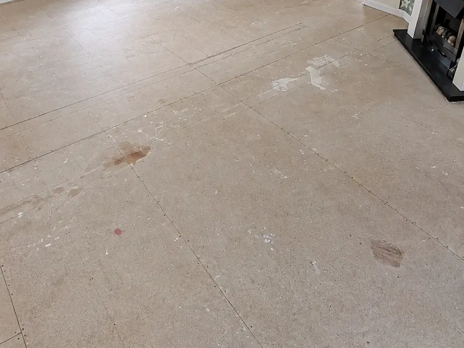 Kitchen-diner before: bare, stained subfloor