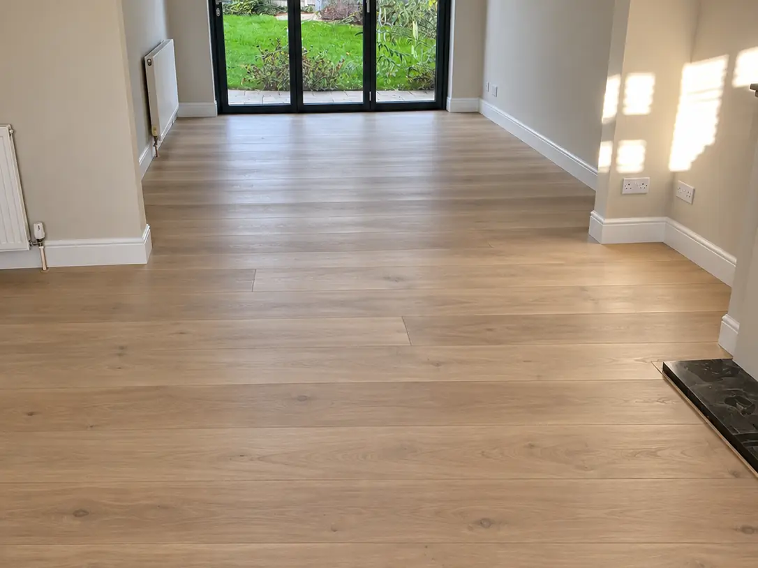 Wide-plank engineered oak flooring in a living room with bi-fold doors to the garden