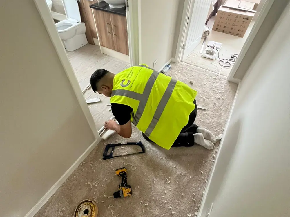 A Cambridgeshire Carpets fitter preparing a bedroom floor for carpet