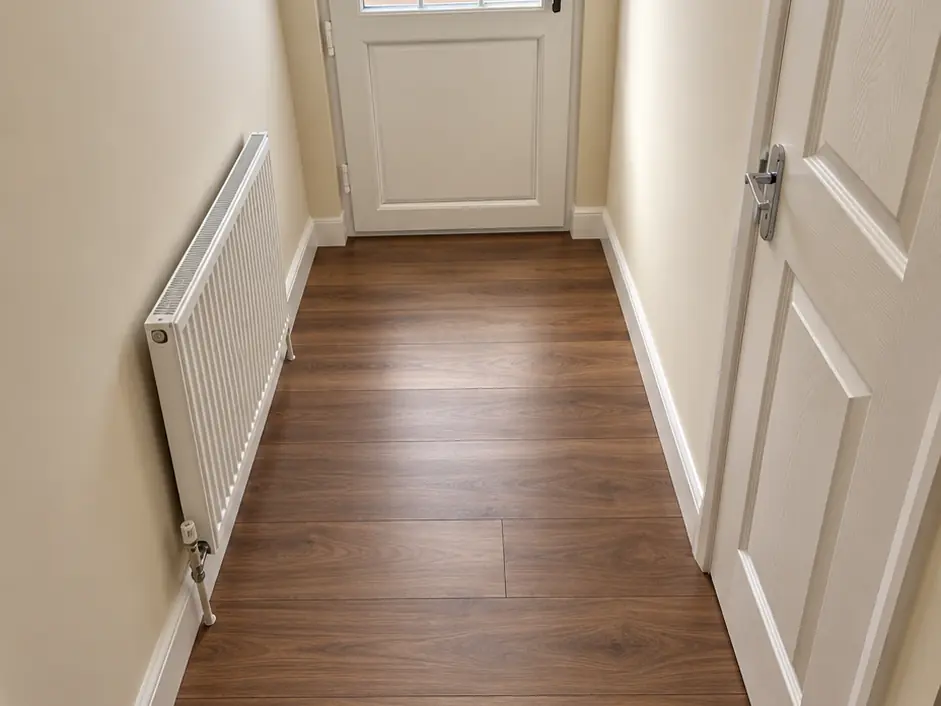 Walnut-effect laminate flooring fitted along a hallway
