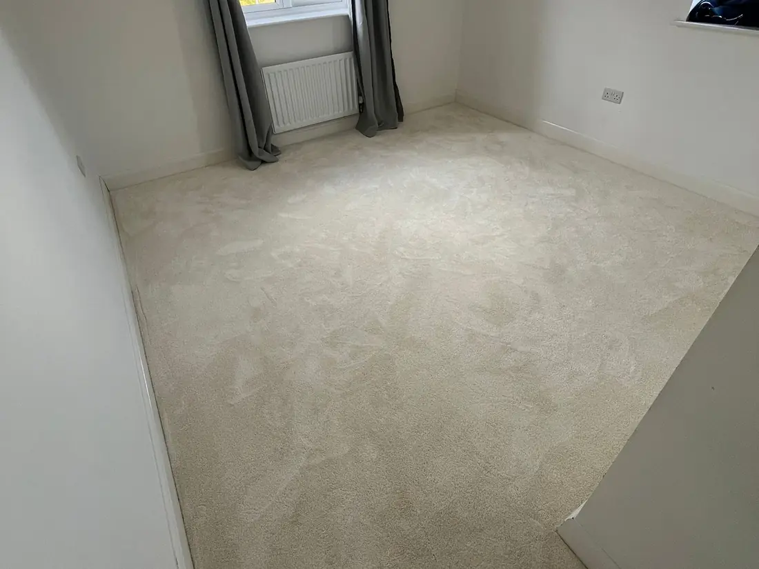 Cream carpet fitted in a bedroom with a large window