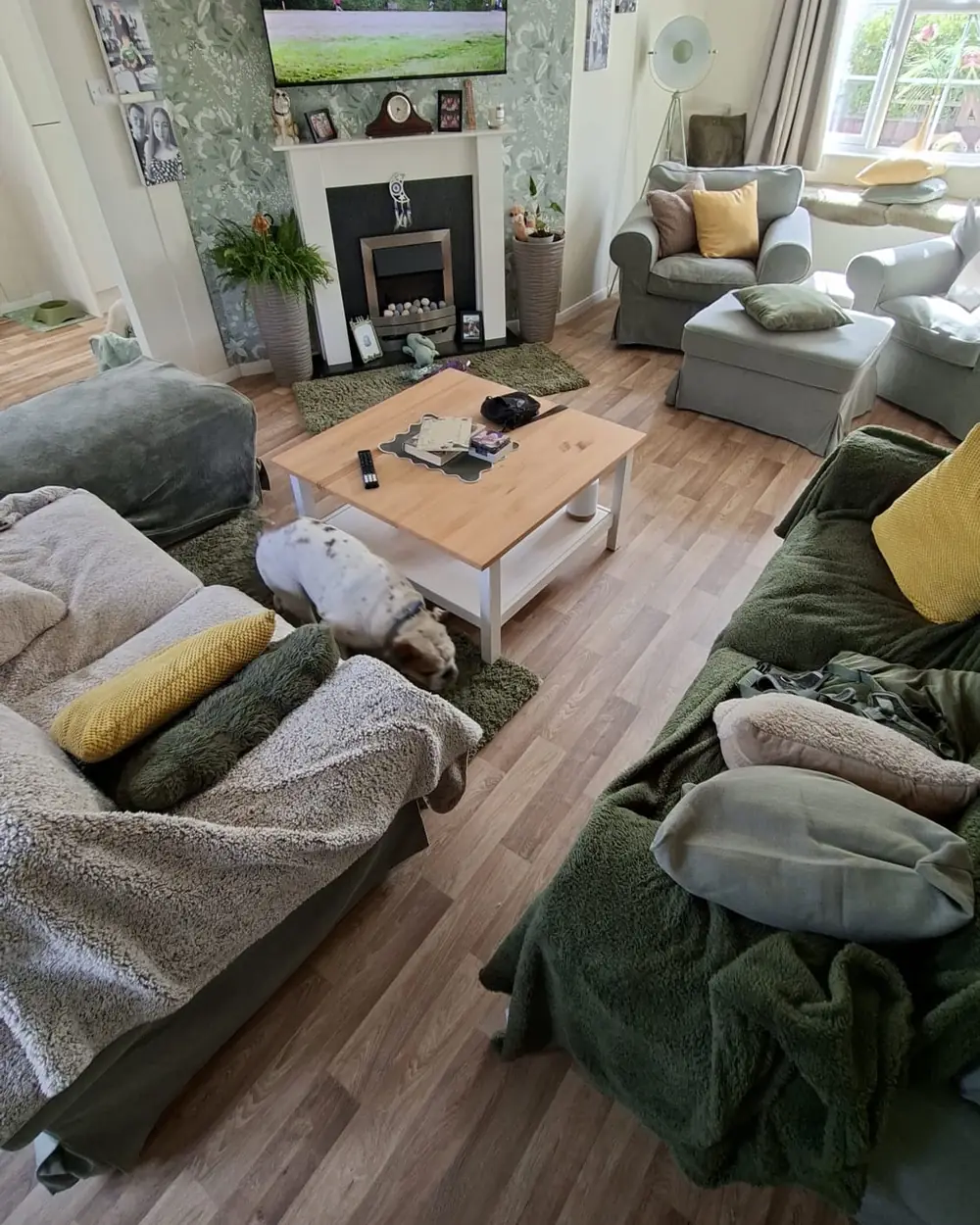 A finished living room with new wood-effect flooring, sofas back in place