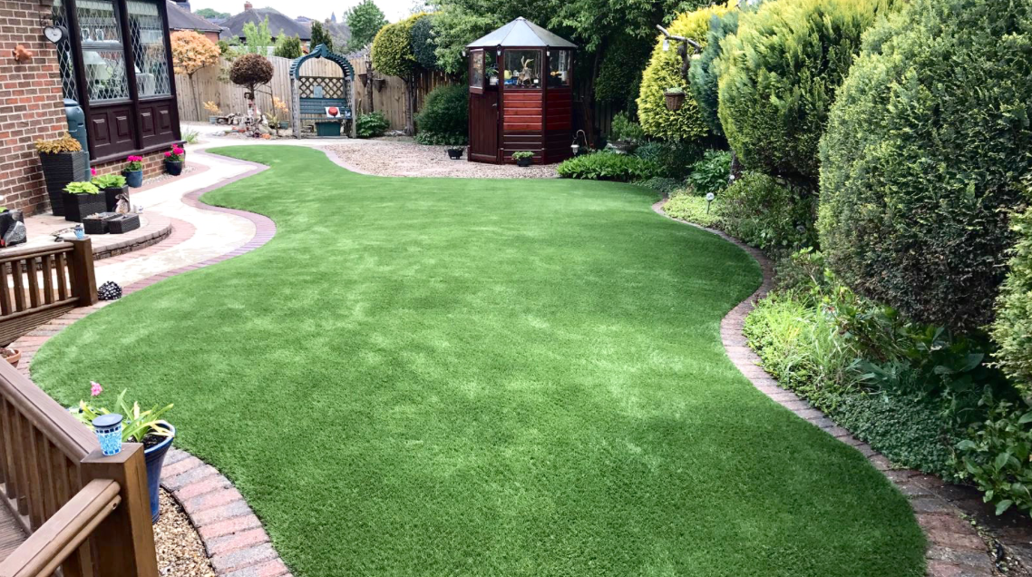 Beautiful artificial grass garden installation in Peterborough by Cambridgeshire Carpets — lush, low-maintenance fake lawn that stays green all year round