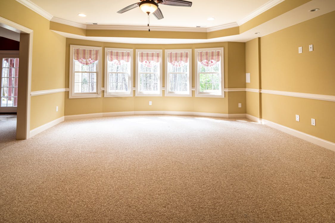 Empty carpeted room in a Peterborough home being prepared for new flooring — carpet removal guide by Cambridgeshire Carpets