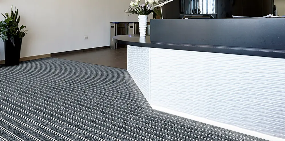 Entrance matting and carpet tiles in a reception area.