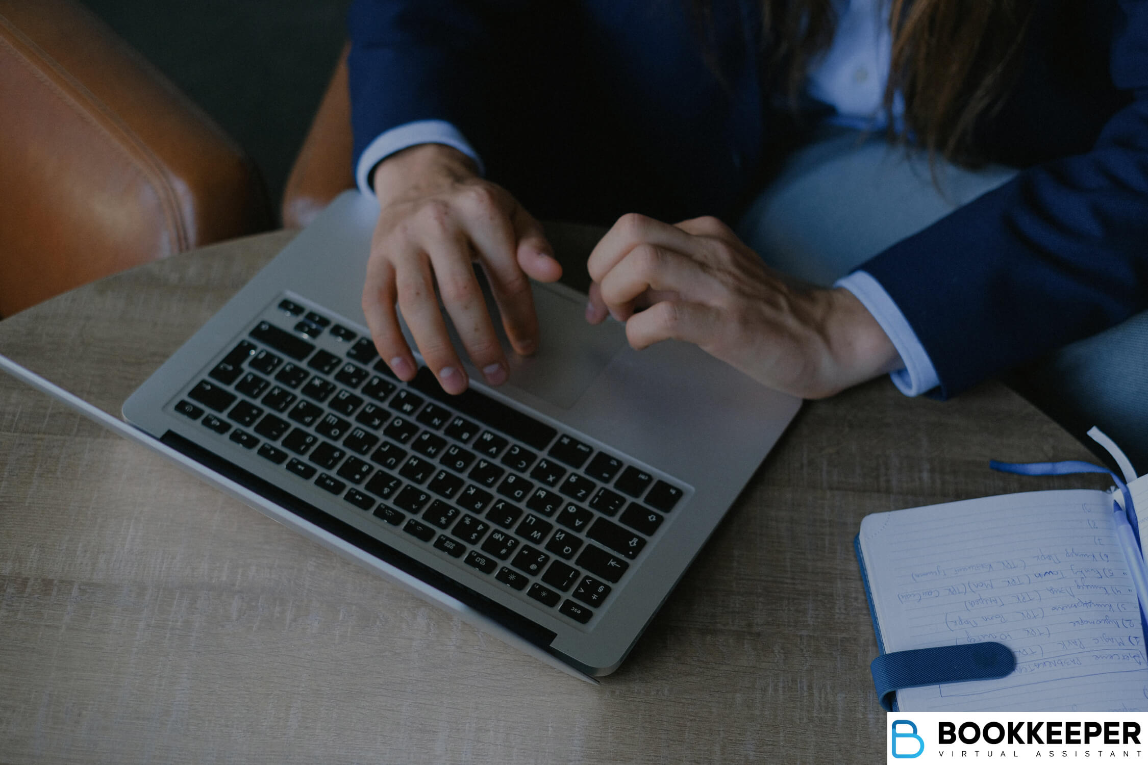 bookkeeper doing tasks with laptop and notes