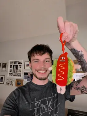 Picture of Evan and a Hotdog Stuffed Animal