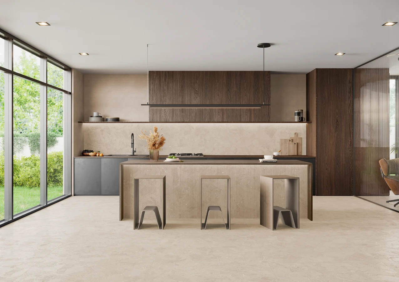 Modern kitchen with beige porcelain tile floor, a central island with stools, wooden cabinets, and large floor-to-ceiling windows overlooking greenery.