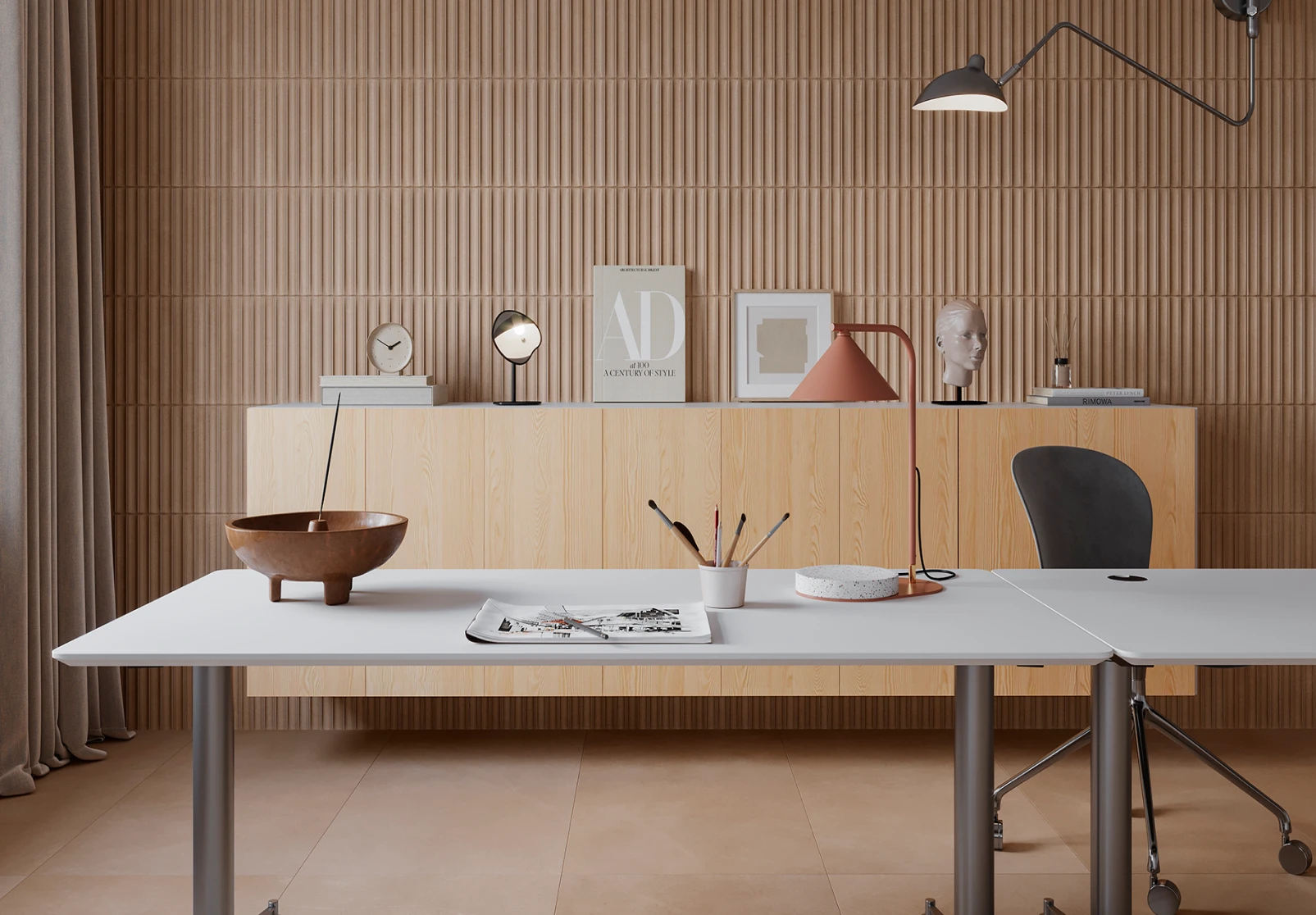 Minimalist workspace with white desks, a black chair, wooden cabinet, decorative items, and a wall lamp in a neutral-toned room.