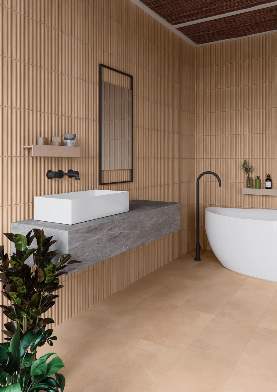 Modern bathroom with beige textured wall tiles, a rectangular white sink on a floating gray marble countertop, a tall black framed mirror, a freestanding white bathtub with a black floor-mounted faucet, and green plants.