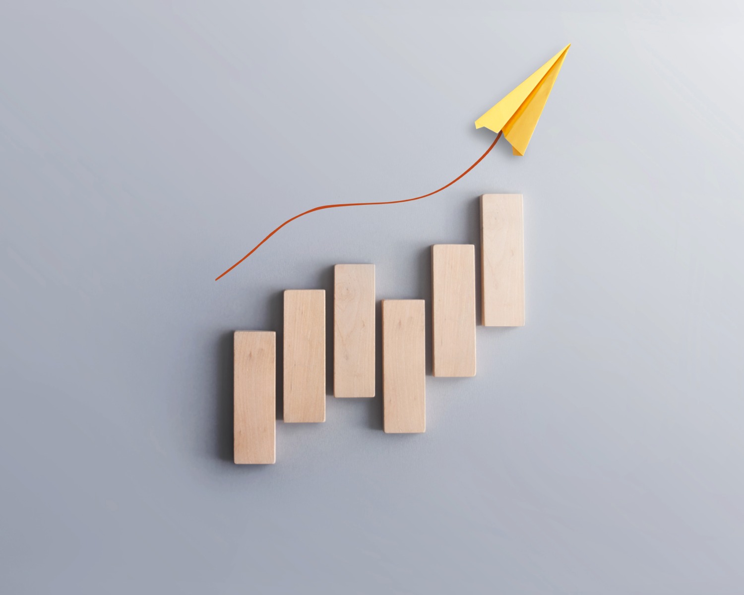 paper airplane following a growing line of trajectory