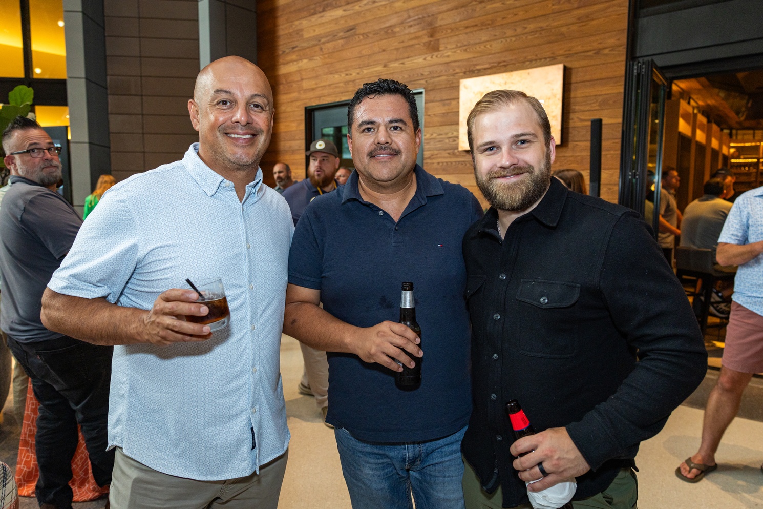Three owners posing shoulder to shoulder at a LeanScaper Intensive