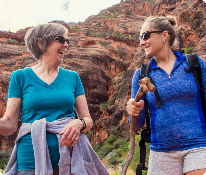 Two attendees laughing on a desert hike