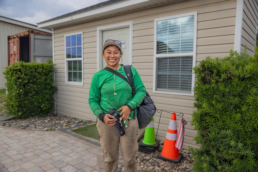 A ProGreen crew member beaming, keys in hand, ready to roll