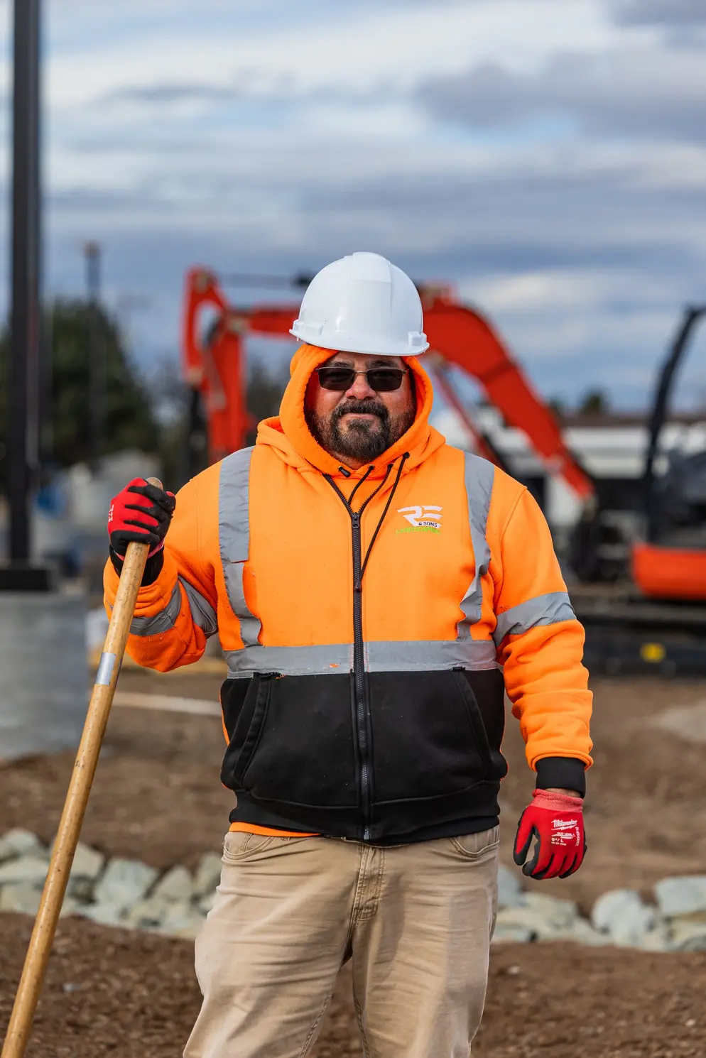 An RE & Sons crew member with his shovel on a commercial site