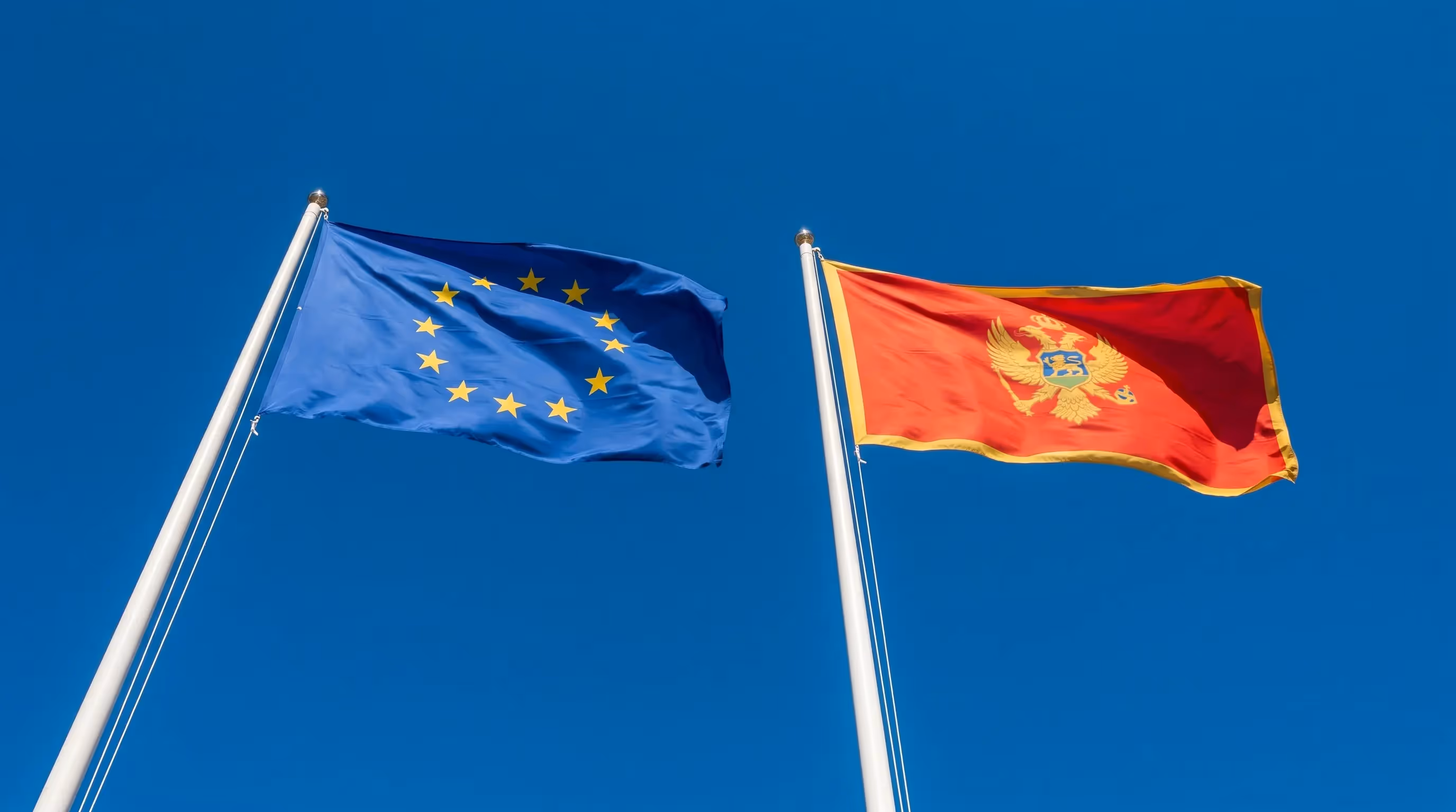 The EU and Montenegrin flags — a relationship that has moved from aspiration to active treaty drafting in 2026