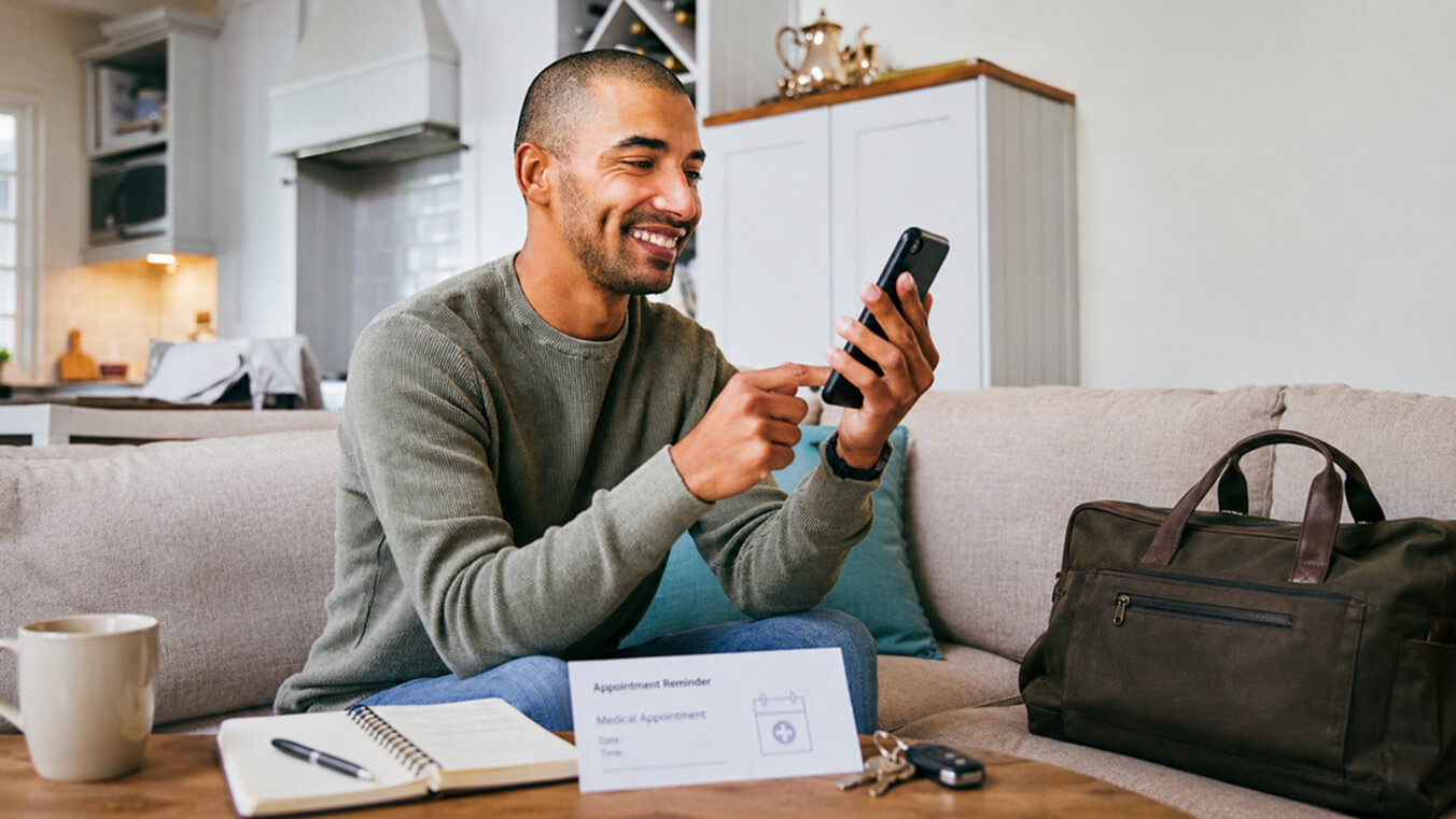 White Card holder booking transport to a medical appointment on a smartphone.