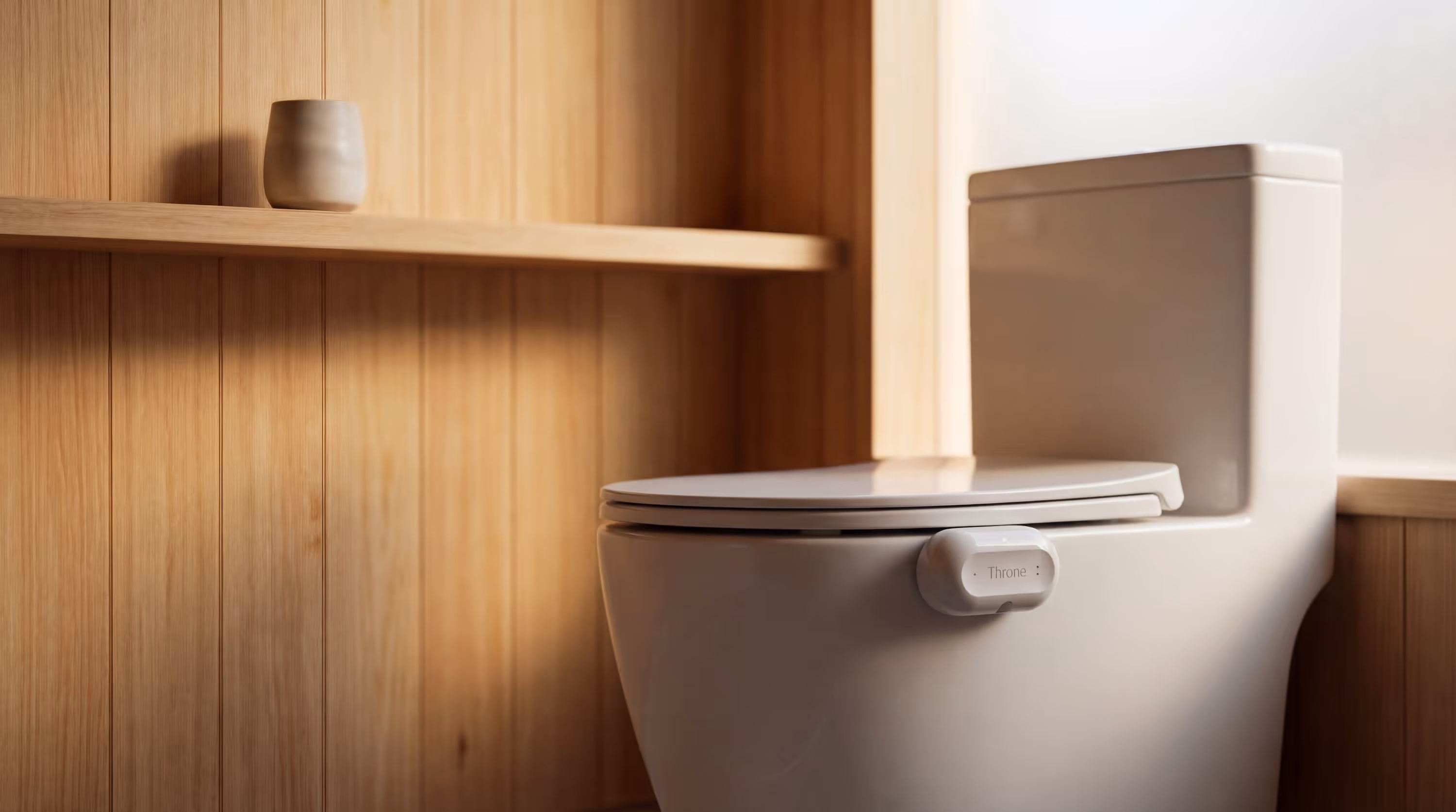 Throne Gut Health Sensor in a naturally lit bathroom with hinoki wood paneling