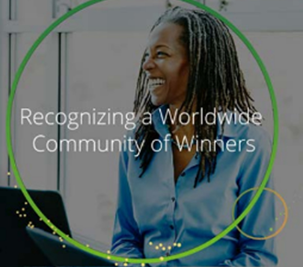 Smiling woman with dreadlocks wearing a blue shirt, with text overlay reading 'Recognizing a Worldwide Community of Winners.'